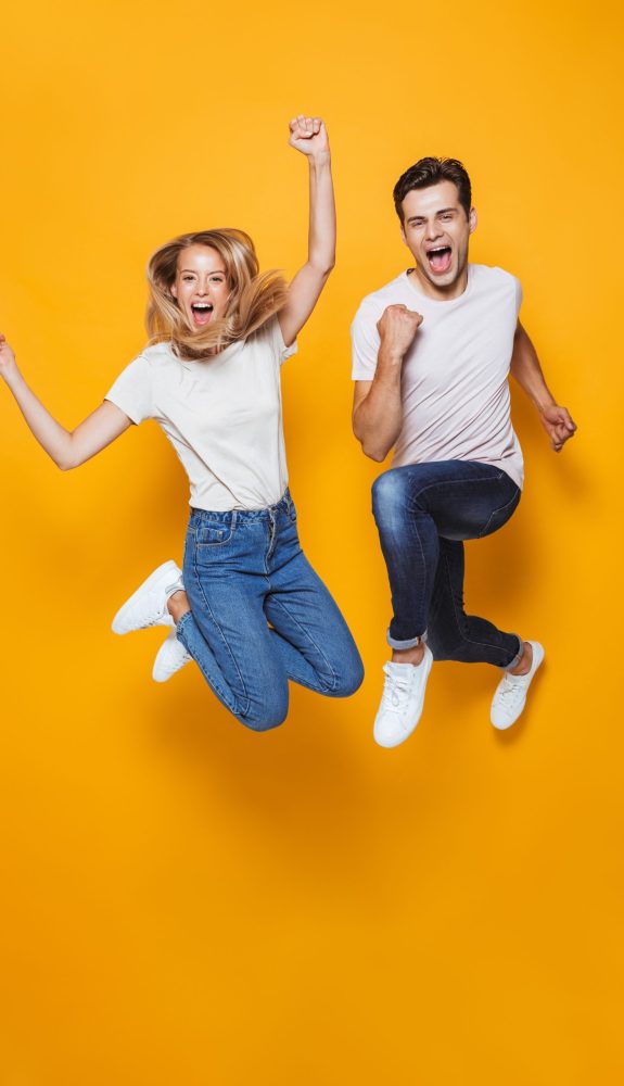 Photo,Of,Happy,Excited,Young,Loving,Couple,Jumping,Isolated,Over